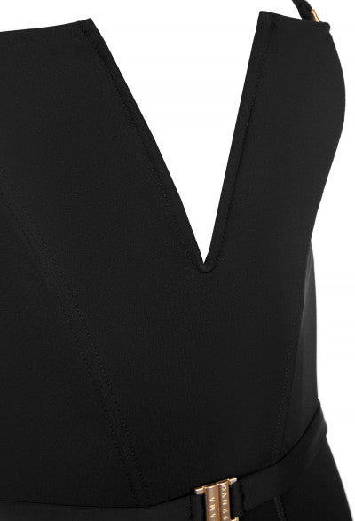 Close-up of a woman's black swimwear, focusing on the V-shaped neckline and gold buckle detail for an elegant touch.